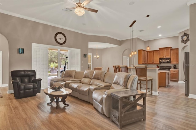 2313 Pesaro Cir, Ocoee, FL 34761 - living area with arched walkways, light wood-style floors, ceiling fan, baseboards, and crown molding