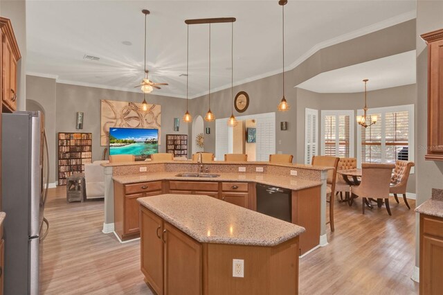 2313 Pesaro Cir, Ocoee, FL 34761 - kitchen featuring freestanding refrigerator, a large island, a sink, dishwasher, and light wood-type flooring