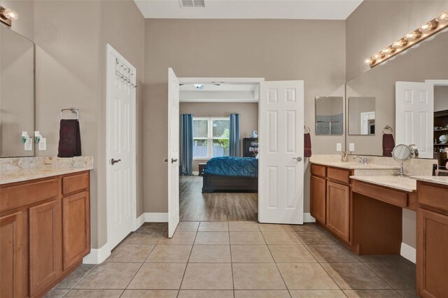 2313 Pesaro Cir, Ocoee, FL 34761 - bathroom featuring connected bathroom, vanity, tile patterned flooring, and baseboards