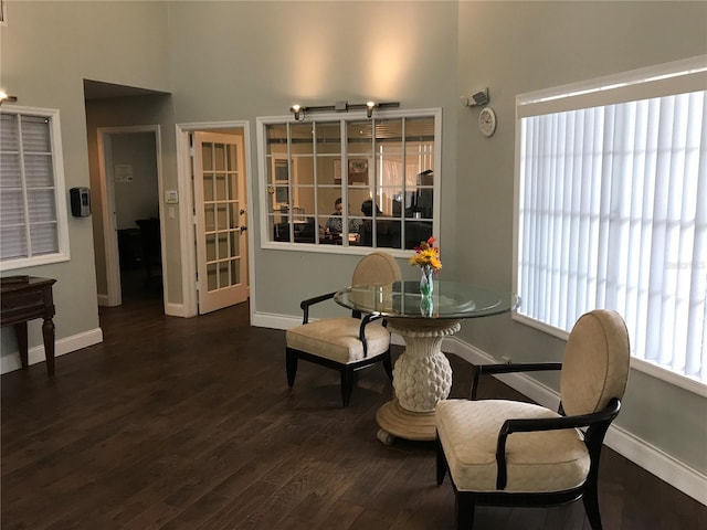 4756 Walden Cir Unit 21, Orlando, FL 32811 - dining area with baseboards, wood finished floors, and a towering ceiling