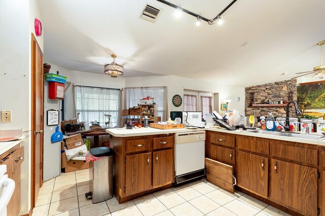 4933 Round Lake Rd, Apopka, FL 32712 - kitchen with white dishwasher, a sink, light countertops, brown cabinetry, and light tile patterned flooring