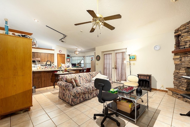 4933 Round Lake Rd, Apopka, FL 32712 - living room with lofted ceiling, ceiling fan, light tile patterned floors, and a textured ceiling