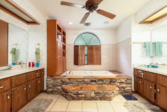 4933 Round Lake Rd, Apopka, FL 32712 - bathroom with two vanities, a bath, wallpapered walls, tile patterned floors, and ceiling fan