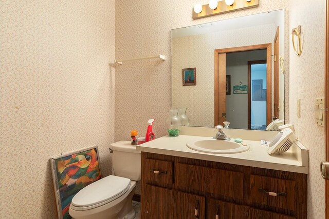 4933 Round Lake Rd, Apopka, FL 32712 - bathroom with wallpapered walls, vanity, and toilet