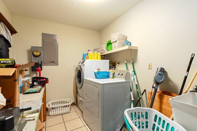 4933 Round Lake Rd, Apopka, FL 32712 - laundry room with electric panel, washing machine and dryer, and light tile patterned floors