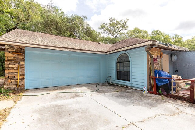 4933 Round Lake Rd, Apopka, FL 32712 - ranch-style home with driveway, an attached garage, and roof with shingles