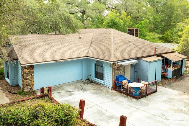 4933 Round Lake Rd, Apopka, FL 32712 - view of front of house with roof with shingles, a chimney, and a wooded view