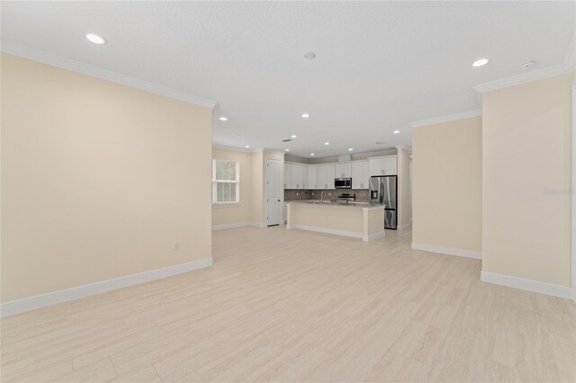 16357 SE 88th Ct, Summerfield, FL 34491 - unfurnished living room with crown molding, recessed lighting, a sink, baseboards, and light wood-type flooring