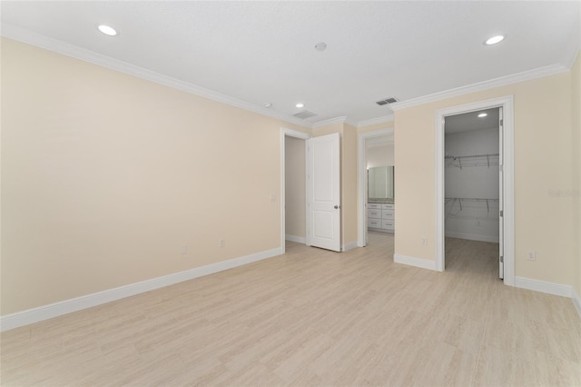 16357 SE 88th Ct, Summerfield, FL 34491 - unfurnished bedroom with light wood-style floors, recessed lighting, a spacious closet, baseboards, and crown molding