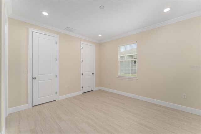 16357 SE 88th Ct, Summerfield, FL 34491 - unfurnished bedroom featuring light wood finished floors, baseboards, crown molding, and recessed lighting