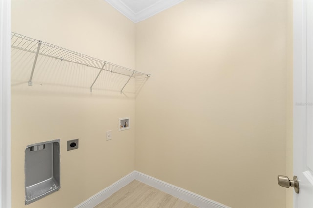 16357 SE 88th Ct, Summerfield, FL 34491 - laundry area featuring hookup for a washing machine, electric dryer hookup, crown molding, baseboards, and light wood finished floors
