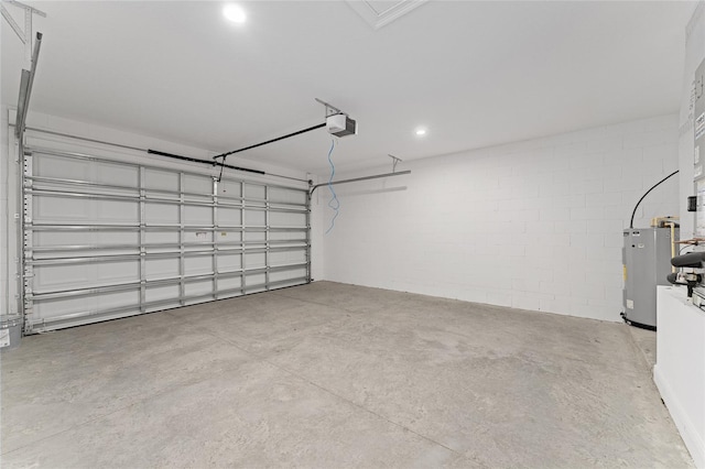 16357 SE 88th Ct, Summerfield, FL 34491 - garage with water heater, a garage door opener, concrete block wall, and recessed lighting
