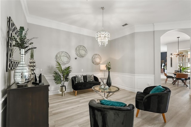 6426 Montclair Bluff Ln, Windermere, FL 34786 - sitting room with a chandelier, arched walkways, wood finished floors, ornamental molding, and a wainscoted wall