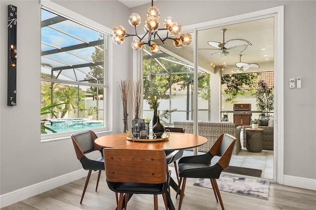 6426 Montclair Bluff Ln, Windermere, FL 34786 - dining space featuring baseboards, a ceiling fan, wood finished floors, and a chandelier