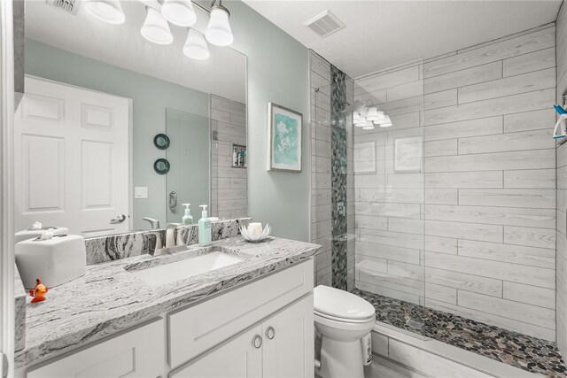 6426 Montclair Bluff Ln, Windermere, FL 34786 - bathroom featuring toilet, vanity, and a tile shower