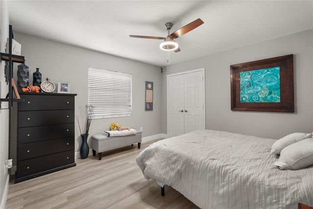 6426 Montclair Bluff Ln, Windermere, FL 34786 - bedroom with light wood-type flooring, a closet, baseboards, and a ceiling fan