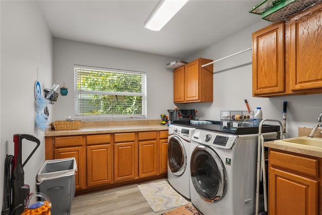 6426 Montclair Bluff Ln, Windermere, FL 34786 - washroom with cabinet space, washer and clothes dryer, and light wood-style floors