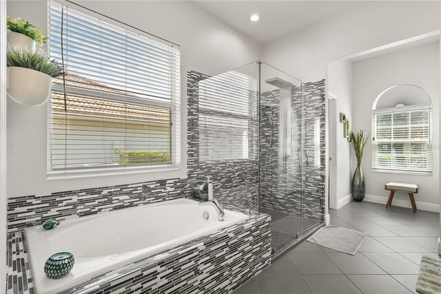 6426 Montclair Bluff Ln, Windermere, FL 34786 - bathroom featuring a bath, a stall shower, tile patterned flooring, healthy amount of natural light, and recessed lighting