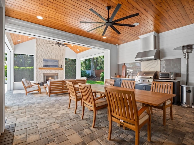 340 Lakeview Rd, Winter Garden, FL 34787 - dining space featuring a ceiling fan, wooden ceiling, vaulted ceiling, a fireplace, and stone finish floors