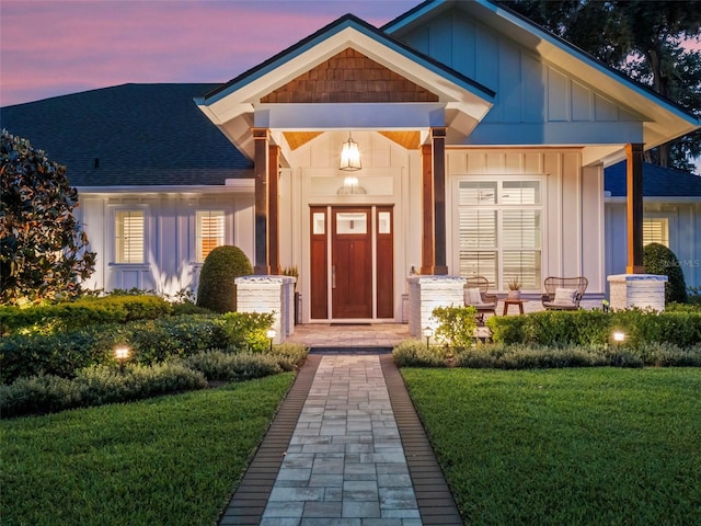 340 Lakeview Rd, Winter Garden, FL 34787 - view of front of home with board and batten siding, roof with shingles, a front lawn, and a porch