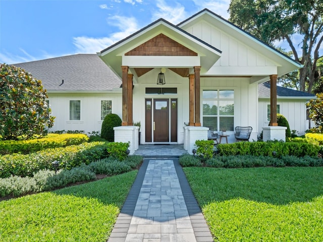 340 Lakeview Rd, Winter Garden, FL 34787 - view of front of property with board and batten siding, a shingled roof, a porch, and a front yard