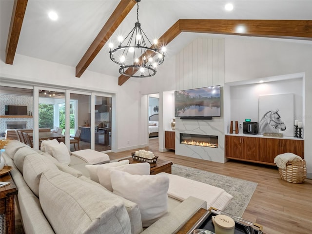 340 Lakeview Rd, Winter Garden, FL 34787 - living room with a premium fireplace, beamed ceiling, a chandelier, light wood finished floors, and high vaulted ceiling