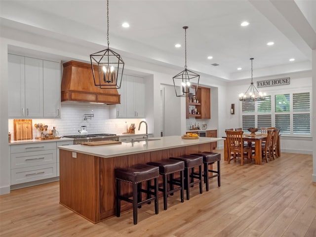 340 Lakeview Rd, Winter Garden, FL 34787 - kitchen with premium range hood, a chandelier, light countertops, light wood finished floors, and recessed lighting