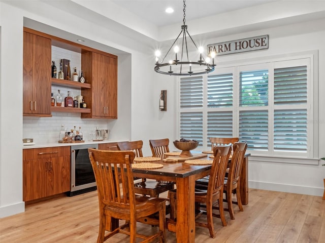 340 Lakeview Rd, Winter Garden, FL 34787 - dining space with beverage cooler, a chandelier, a bar, light wood-style floors, and recessed lighting