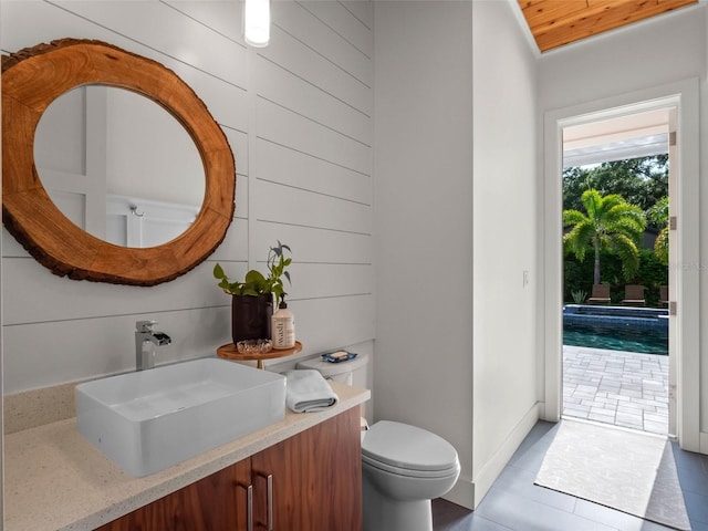 340 Lakeview Rd, Winter Garden, FL 34787 - bathroom with tile patterned flooring, vanity, wooden ceiling, and wood walls