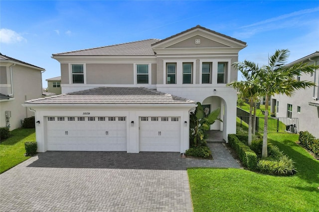5609 Zestar Ln, Loxahatchee, FL 33470 - view of front facade featuring decorative driveway, stucco siding, a tile roof, and an attached garage