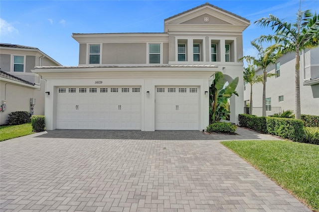 5609 Zestar Ln, Loxahatchee, FL 33470 - view of front of property featuring decorative driveway, stucco siding, and a garage