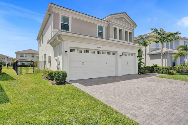 5609 Zestar Ln, Loxahatchee, FL 33470 - view of front facade with a garage, stucco siding, and decorative driveway
