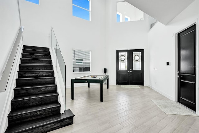 5609 Zestar Ln, Loxahatchee, FL 33470 - entrance foyer featuring stairs, a towering ceiling, light wood finished floors, french doors, and baseboards
