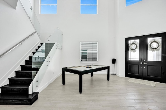 5609 Zestar Ln, Loxahatchee, FL 33470 - entryway with a towering ceiling, stairway, wood finished floors, french doors, and baseboards