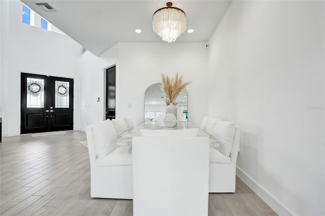 5609 Zestar Ln, Loxahatchee, FL 33470 - dining area with light wood-type flooring, arched walkways, a chandelier, baseboards, and recessed lighting