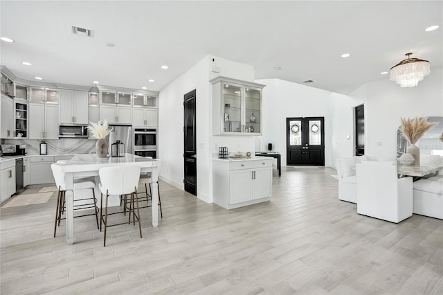 5609 Zestar Ln, Loxahatchee, FL 33470 - kitchen featuring stainless steel appliances, open floor plan, a center island, a kitchen bar, and recessed lighting