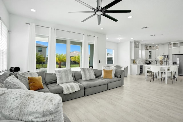 5609 Zestar Ln, Loxahatchee, FL 33470 - living area with ceiling fan, recessed lighting, light wood-type flooring, and beverage cooler