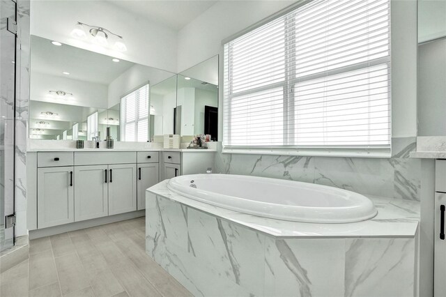 5609 Zestar Ln, Loxahatchee, FL 33470 - full bath with a bath, plenty of natural light, and vanity