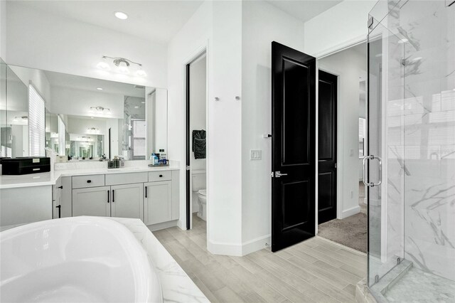 5609 Zestar Ln, Loxahatchee, FL 33470 - full bathroom with a marble finish shower, toilet, vanity, and wood finished floors