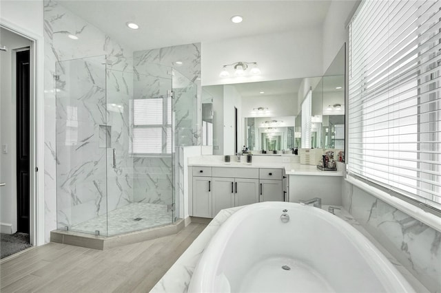 5609 Zestar Ln, Loxahatchee, FL 33470 - full bath with a marble finish shower, vanity, a bathtub, recessed lighting, and wood finished floors
