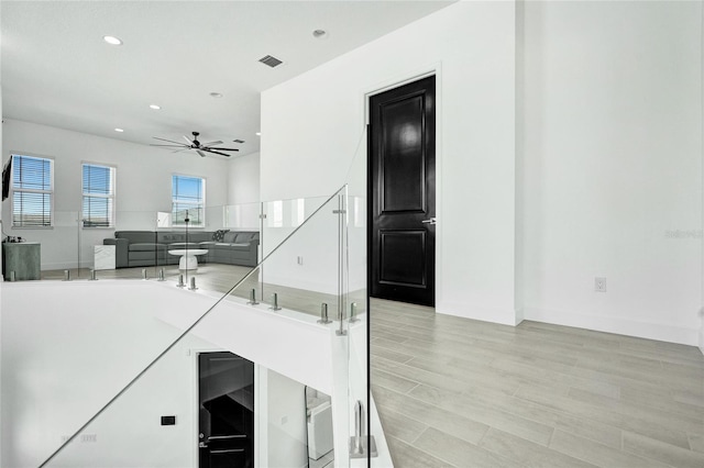 5609 Zestar Ln, Loxahatchee, FL 33470 - staircase featuring ceiling fan, recessed lighting, and wood finished floors
