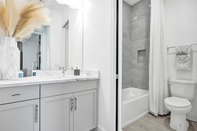 5609 Zestar Ln, Loxahatchee, FL 33470 - bathroom featuring vanity, wood finished floors, shower / tub combo, toilet, and baseboards