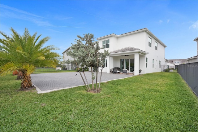 5609 Zestar Ln, Loxahatchee, FL 33470 - back of property with ceiling fan, stucco siding, and a patio area