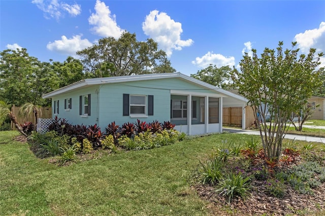588 Hwy 630 E, Frostproof, FL 33843 - view of front of house with a sunroom, a carport, and driveway