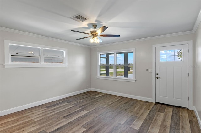 588 Hwy 630 E, Frostproof, FL 33843 - entryway with healthy amount of natural light, wood finished floors, baseboards, ceiling fan, and ornamental molding