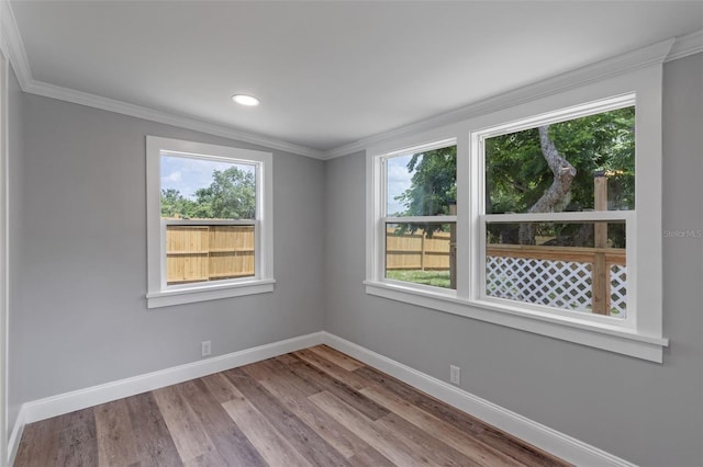 588 Hwy 630 E, Frostproof, FL 33843 - unfurnished room featuring plenty of natural light, baseboards, crown molding, wood finished floors, and recessed lighting