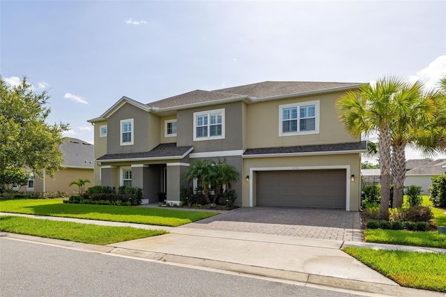 1113 Fieldstone Cir, Oviedo, FL 32765 - view of front facade featuring an attached garage, driveway, a front lawn, and stucco siding