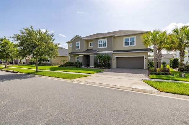 1113 Fieldstone Cir, Oviedo, FL 32765 - view of front of home featuring a garage, driveway, stucco siding, and a front yard