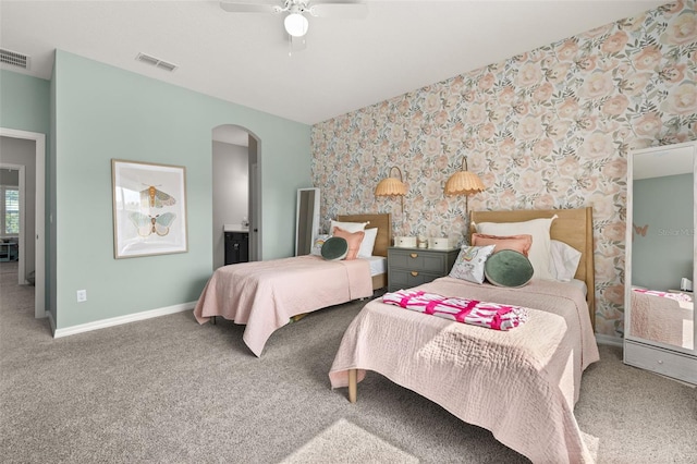 1113 Fieldstone Cir, Oviedo, FL 32765 - bedroom with wallpapered walls, arched walkways, carpet, ceiling fan, and ensuite bathroom