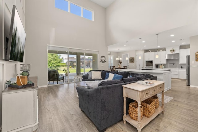 1113 Fieldstone Cir, Oviedo, FL 32765 - living area featuring light wood-style flooring and a towering ceiling